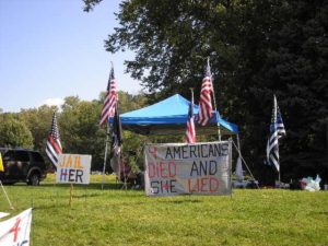 llinois LiberTEA fest organizers arrived early, got a very strategic spot, set up a shade tent, cooler of water and even a camp grill for hot dogs. They had extra signs for spontaneous protest participants